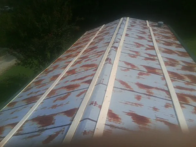 Rusted metal roof panels with new wood purlins before replacement — Storm Damage Roof Repair in Rockmart by Roofing Brothers