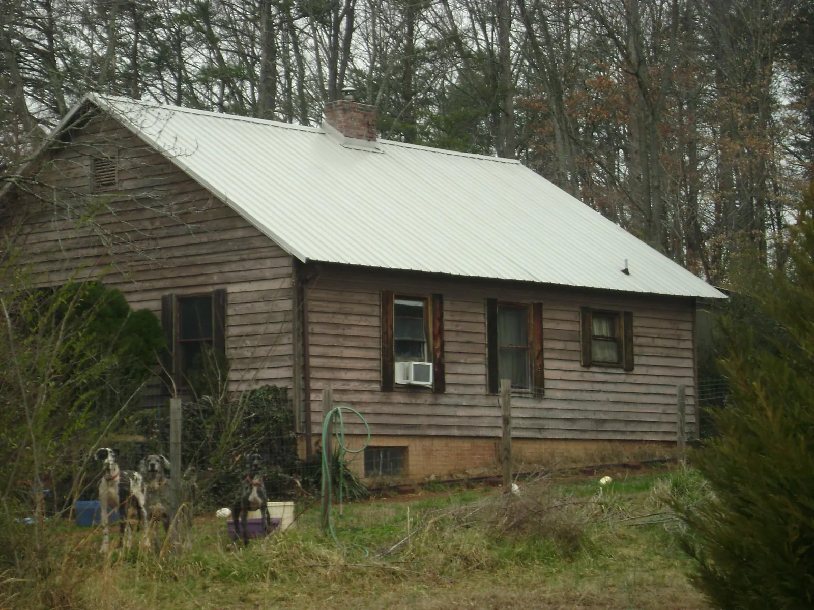 White metal roof on an old wood sided farmhouse, from a Metal Roof Installation job in Rockmart